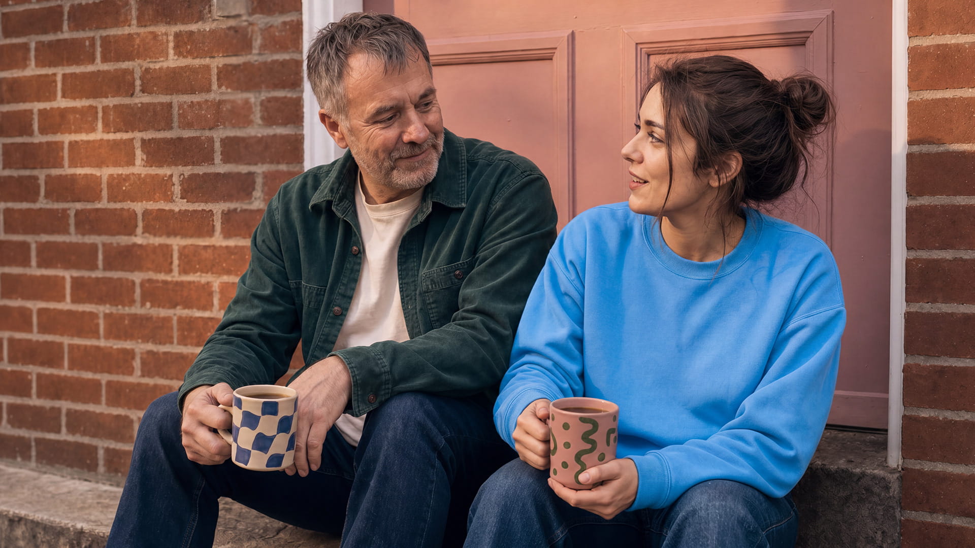 Two guarantors chatting on a sofa